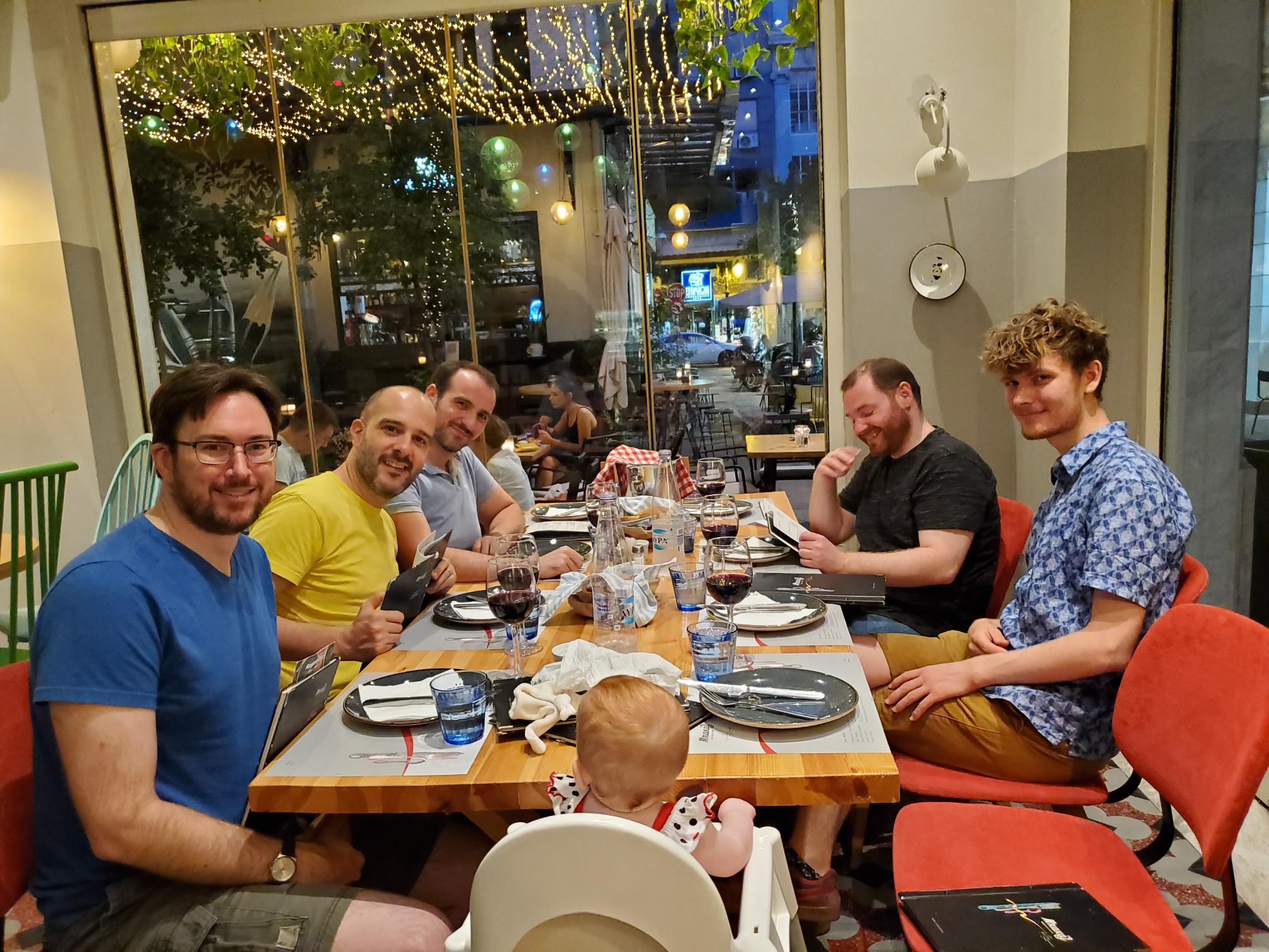 Purism team members sitting around a dinner table at a restaurant