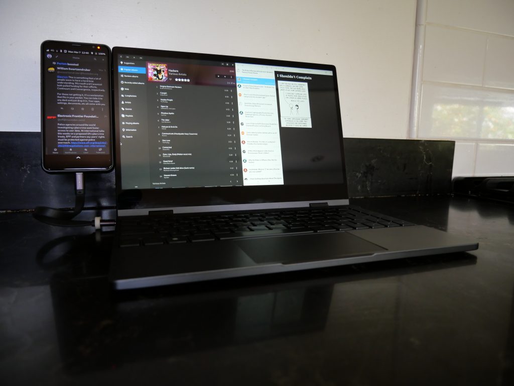 Librem 5 Docked to a Nexdock 360 running Tootle, Lollypop, and Feeds