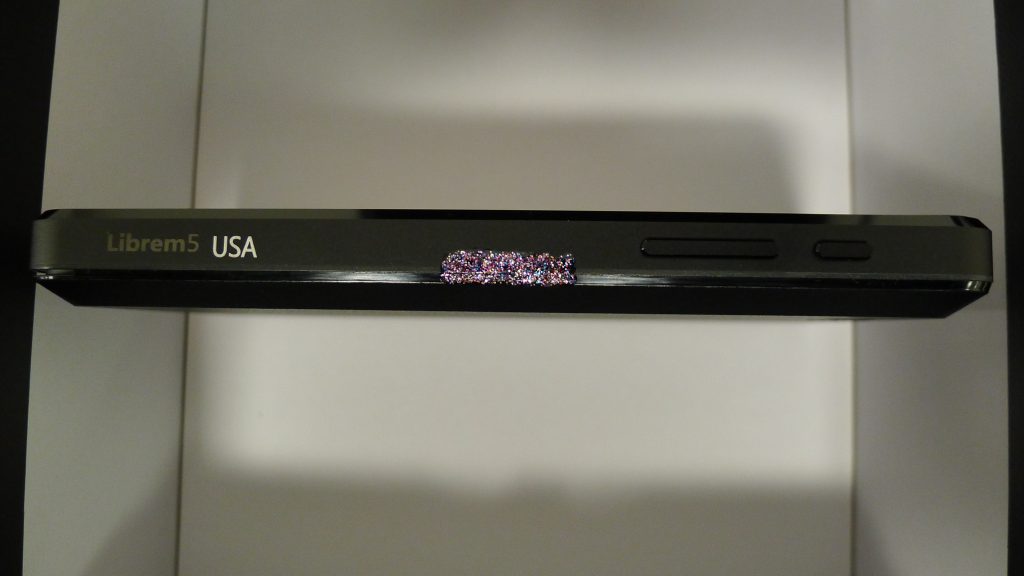 The right side of the Librem 5 USA painted with purple glitter nail polish for anti-interdiction