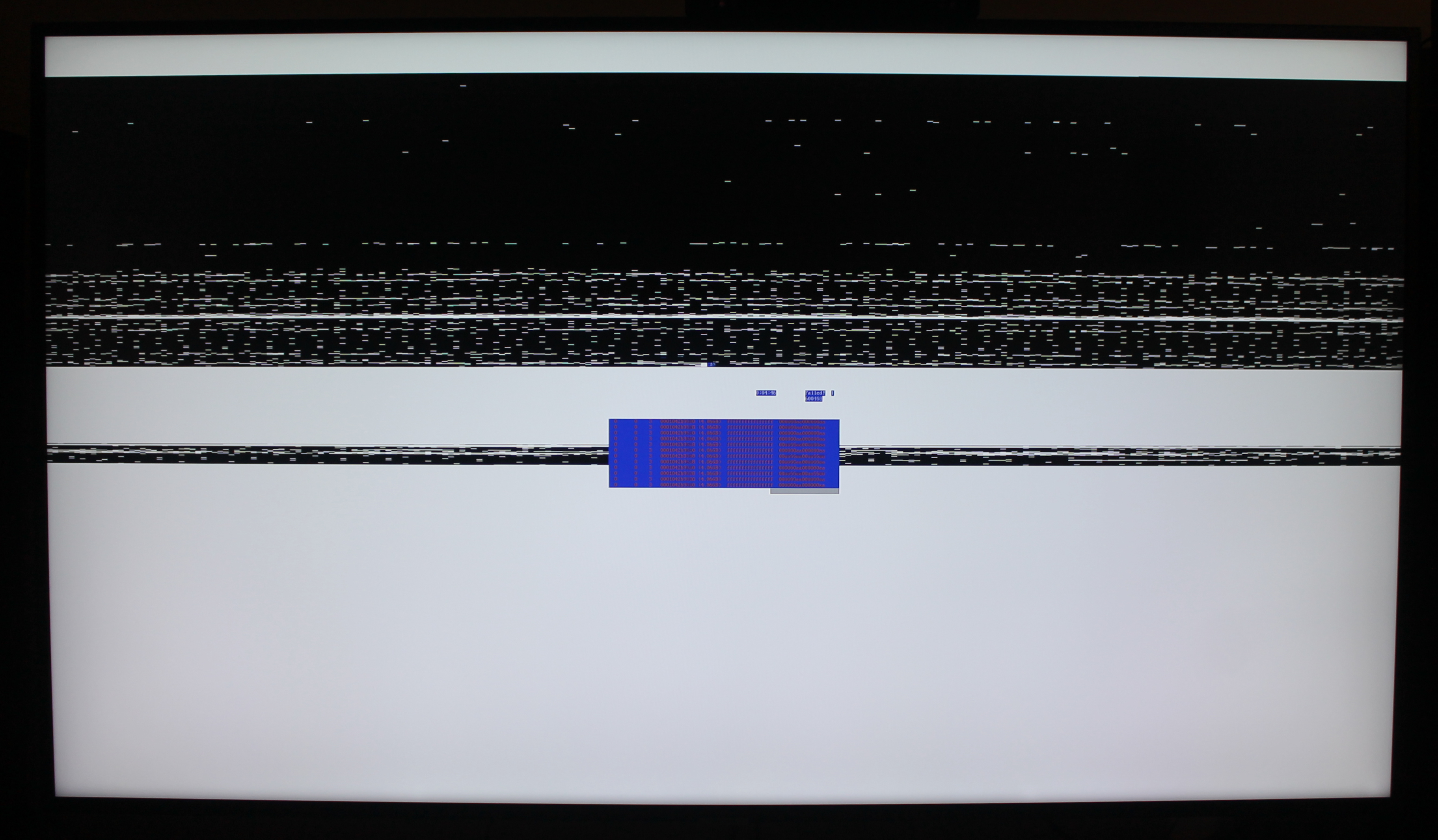 Photo of 4K TV showing partial memtest86+ output in front of bands of black and white. Horizontal white fragments appear in the black bands.