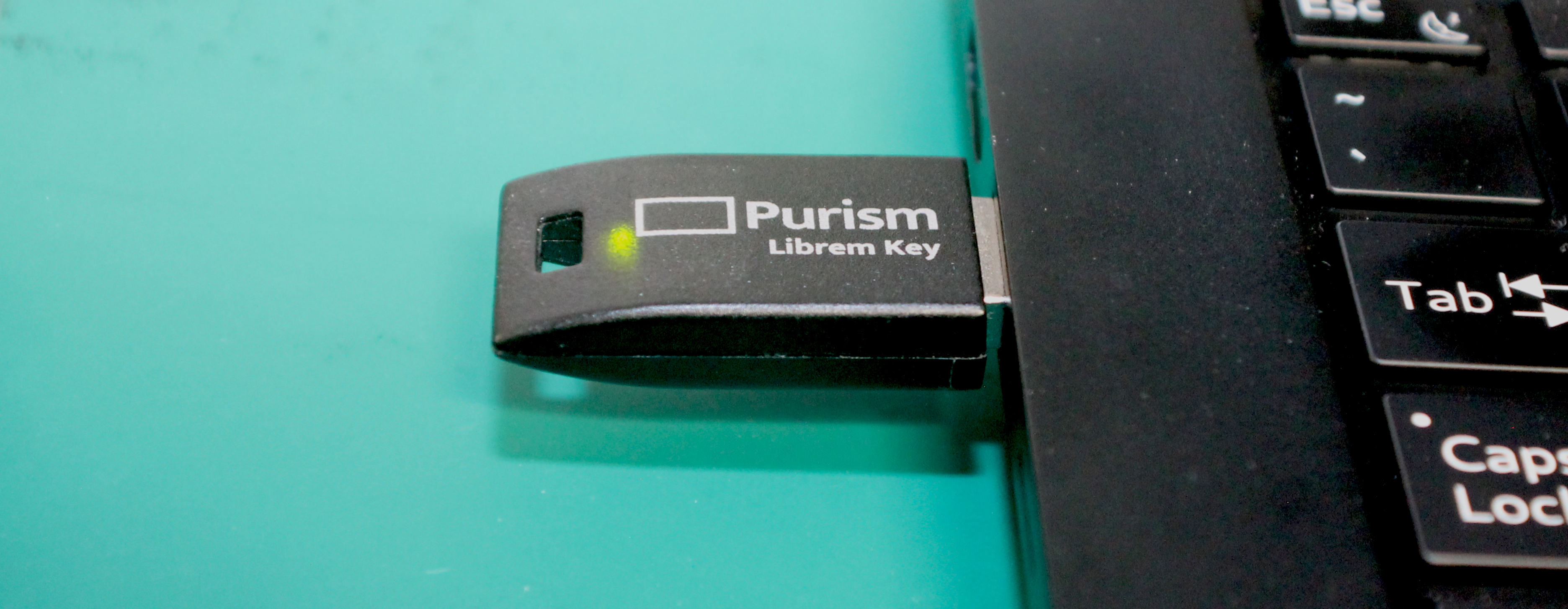 Photo of Librem Key inserted into Librem 14, with green LED lit