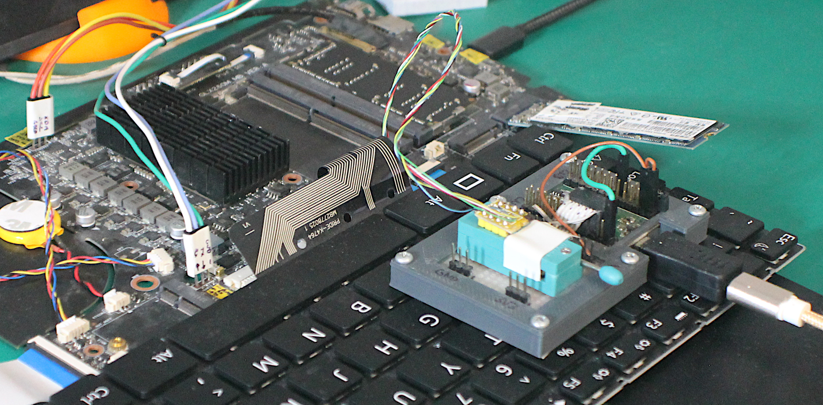Photo of Librem 16 development board, with EC I2C and UART debugging connectors, and flash cable connected to BIOS flash